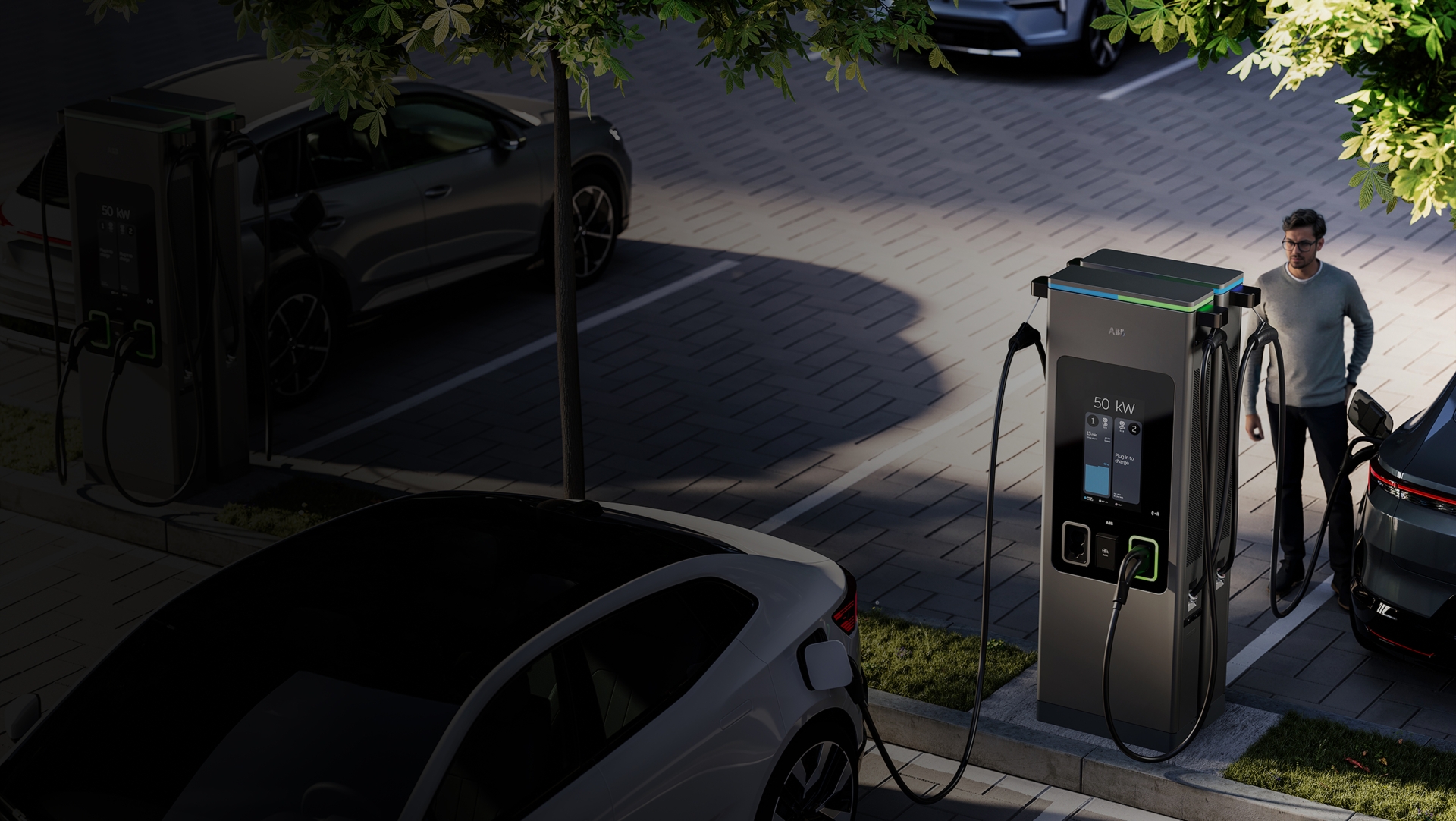 A man interacts with a C50 charger to charge his car in a carpark