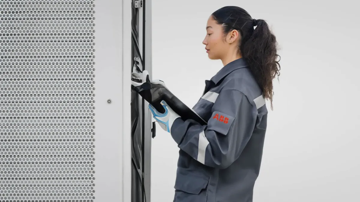 ABB E-mobility employee servicing an EV charger 