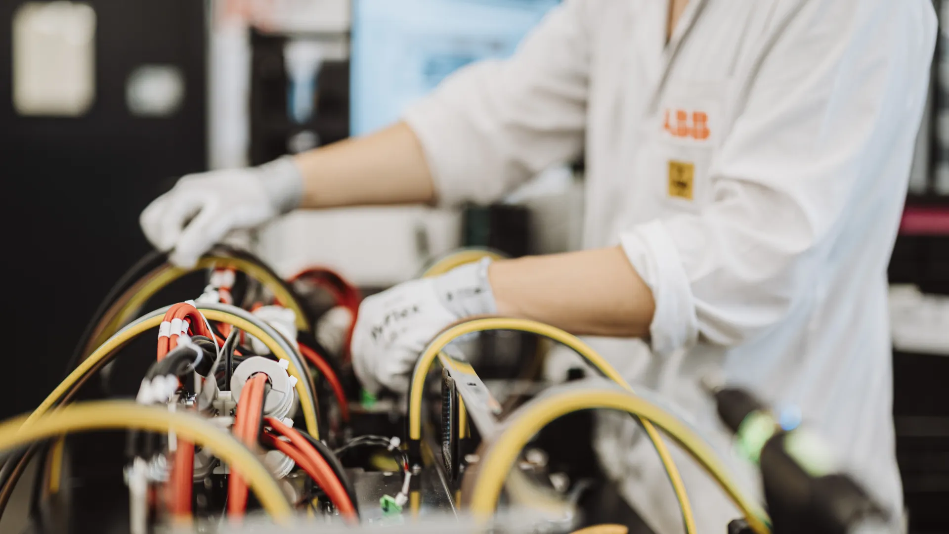 Engineer in gloves assembling and testing electronic components