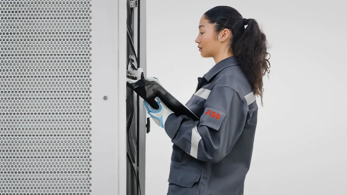ABB E-mobility employee servicing an EV charger 