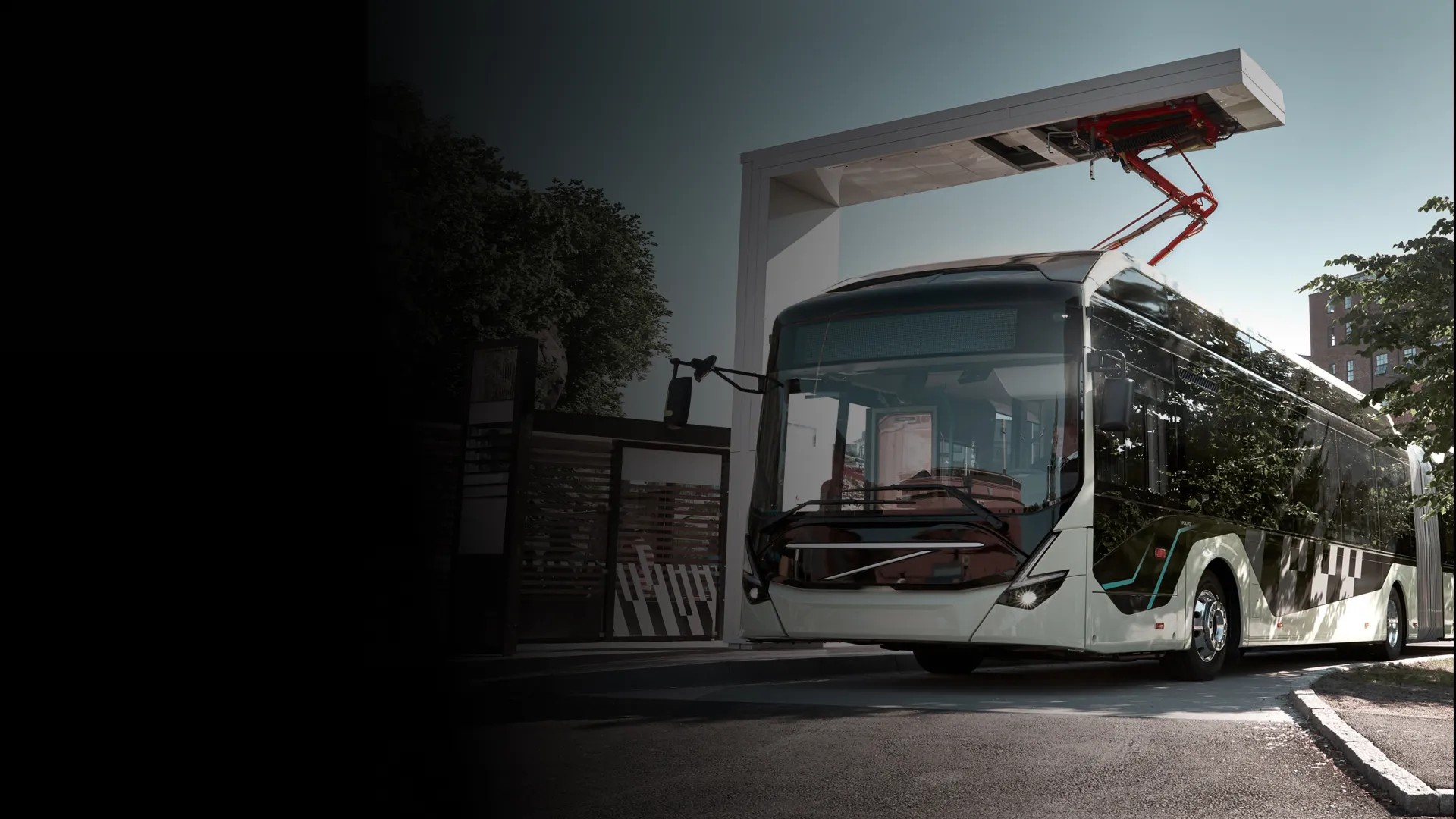 A bus charges at a stop on route using a pantograph down system