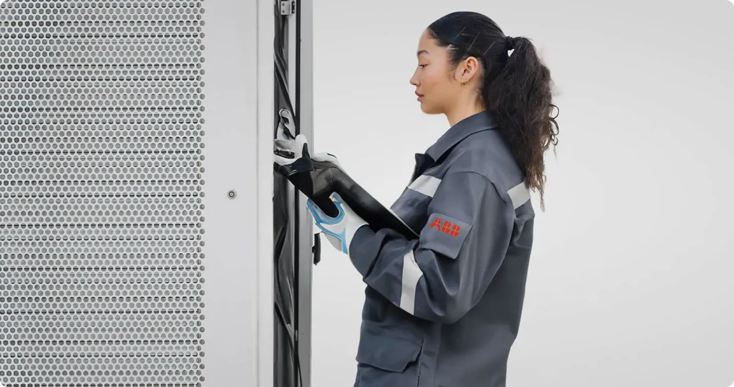 ABB E-mobility employee servicing an EV charger 
